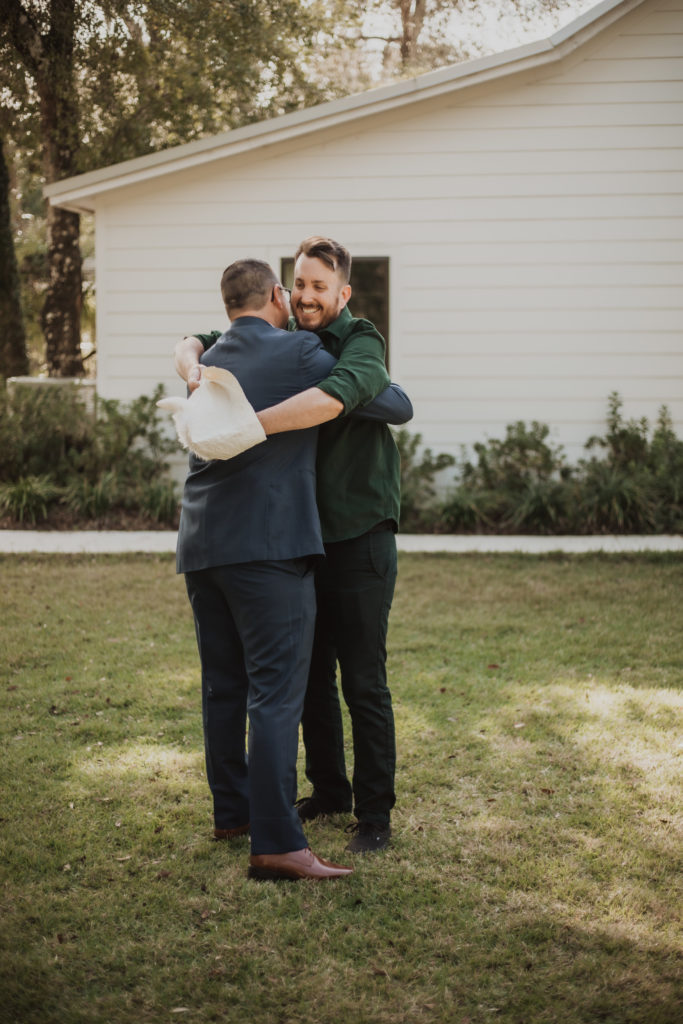 groom and friend silly first look at chandler oaks