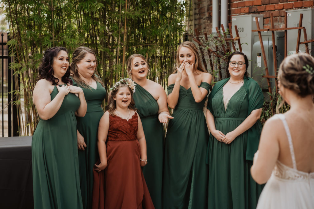 bridesmaids looking at bride at brick and beam