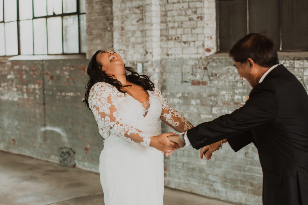 bride having fun with first look